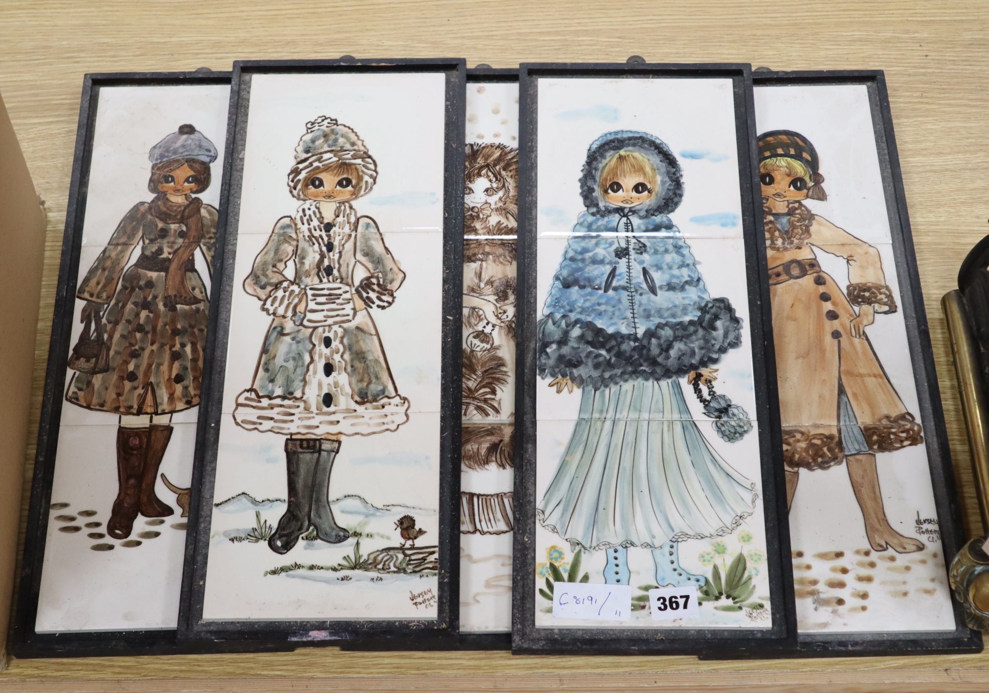Five framed sets of three Jersey Pottery tile plaques, depicting ladies dressed for winter, 46 x 15cm